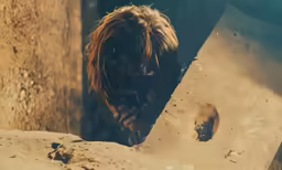 a man is digging a hole in the sand