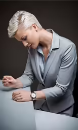 a lady sitting at a table posing for a photo