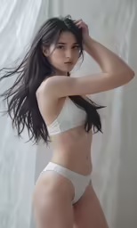 a woman in a white underwear poses