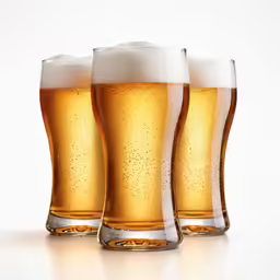 three glasses filled with beer, and two full glasses of beer next to each other