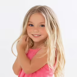 a smiling young girl with long blond hair and blue eyes
