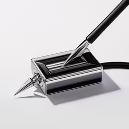 a pen and ink container sitting on a table