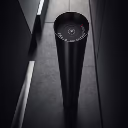 black vase stands in the middle of a line of white cabinets