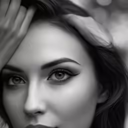black and white photo of woman with hand over her head