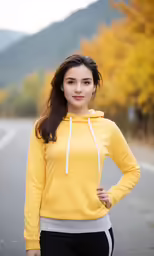 a woman with long hair standing next to a tree