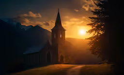 the sun sets behind the church as it is seen