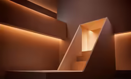 a set of stairs that are illuminated by light from above
