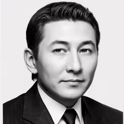 an black and white photo of a man wearing a suit