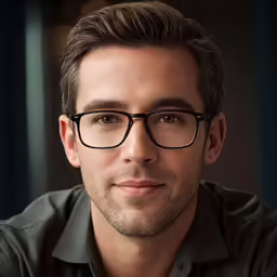 a man in glasses posing for a picture