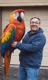 a man holding up a large colorful parrot