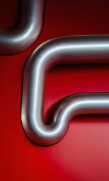 an abstractly shaped silver tube in red