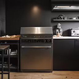 a kitchen with dark colored walls and black cabinets