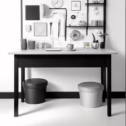 a desk with a chair, some pictures and a vase on top