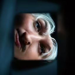 a woman looking at herself in the mirror