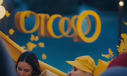 people wearing hats and yellow dress with lit candles