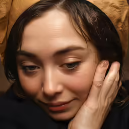 woman with head piece and black dress smiling