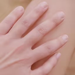 a close up of a person wearing a wedding band