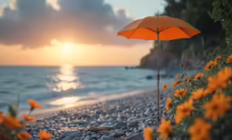 an orange umbrella stands on a rocky beach at sunset