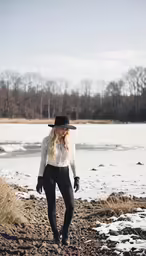 a woman with long blonde hair wearing a hat and black tights