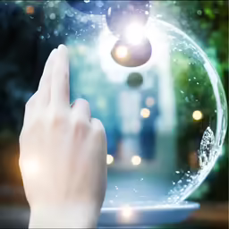 a hand is touching an object with lights in the background