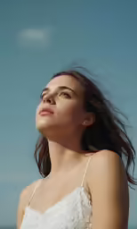 an attractive young woman in a white dress