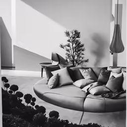 a couch sitting on top of a floor covered in pillows