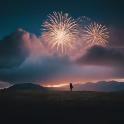 fireworks in the sky above a dark valley