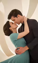 a pregnant woman in a gown standing next to her husband