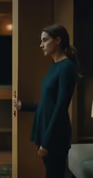 a girl is opening the door to a dark room