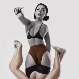 a woman in a black top is holding a cigarette