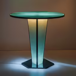 a tall green table with a glowing lamp next to it