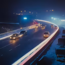 multiple cars driving on the highway at night