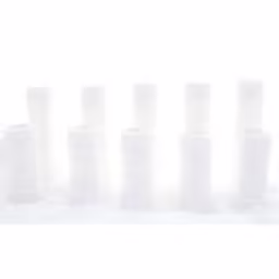 a line up of white vases on a snow covered surface