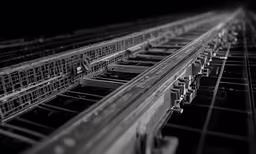 multiple empty steel rails in a rail yard