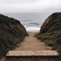 a trail is being built on a beach near a cliff