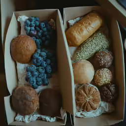 two boxes that are filled with different types of bread