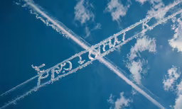 there are contrails in the sky with the word air crafts written below them