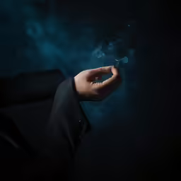 a man is holding something blue in his hand