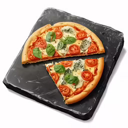 a sliced pizza on a black stone serving board
