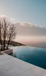 an empty pool is surrounded by trees and the sky