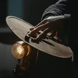 someone is touching their hat on the old fashioned light