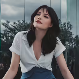 the woman is wearing a white top and blue skirt