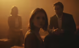 a man sits next to a woman in a room