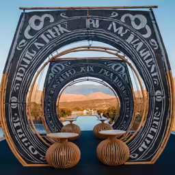 this is an outdoor sculpture with two vases inside of it