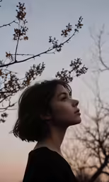 a woman looking to her left as the sky is gray