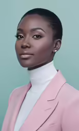 a woman in pink coat and turtle neck sweater