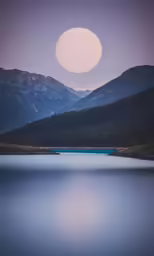 moonlit over a calm lake in the mountains