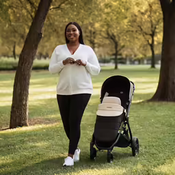 a woman and her baby stroller smiling at the camera