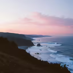 a photo taken from the top of a hill near the beach