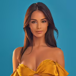 the beautiful girl wearing a yellow dress poses in front of a blue background